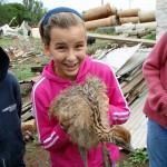 Phoebe holding a baby ostrich
