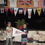 Phoebe and Drake present a Latitude and Attitude´s flag to Anne´s place.