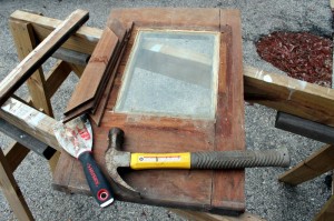 The glass frame was held on by some sealant, and was easy enough to remove with a scraper and hammer.