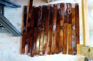 Hatch slats getting a final coat of epoxy before reassembly. The pink is epoxy compound that I used to fill damaged and rotted areas.
