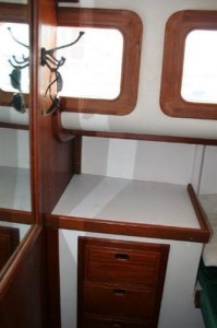 Forward in the aft cabin. You can see mirror on bulkhead and vanity outboard. Bulkhead hits forward starboard window the same place the chart table ends on standard layout.